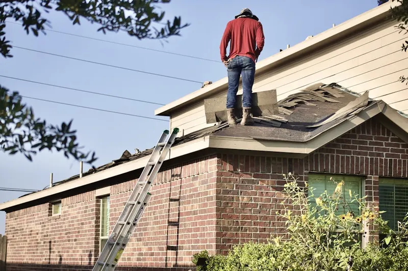 Professional roofer working on a residential roof in St. Michael